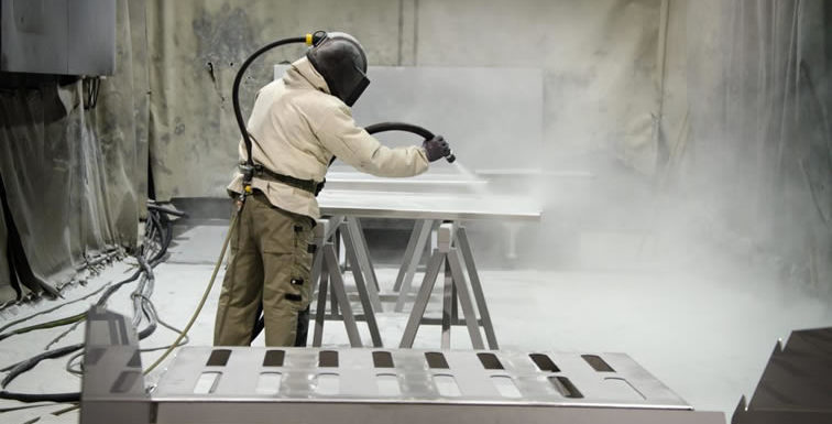 How does a sand blasting machine work?